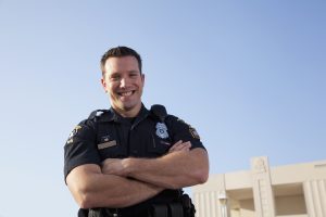 1st Responder Jobs - Young man (20s) in police uniform.
